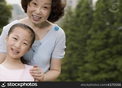 Portrait of a mature woman smiling with her granddaughter