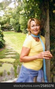Portrait of a mature woman standing and smiling in a park