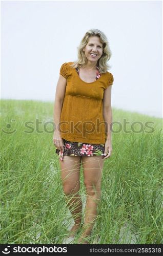 Portrait of a mature woman standing in a grassy field