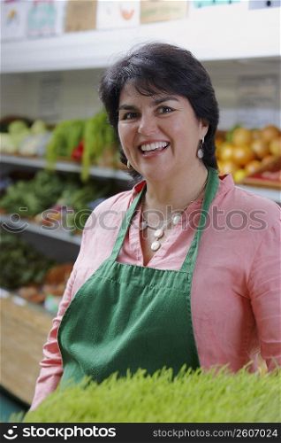 Portrait of a mature woman standing in a grocery store and smiling
