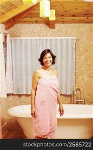 Portrait of a mature woman standing in the bathroom and smiling