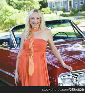 Portrait of a mature woman standing near a car