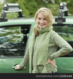 Portrait of a mature woman standing near a car