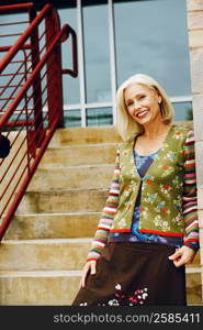 Portrait of a mature woman standing on a staircase and smiling