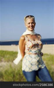 Portrait of a mature woman standing on the beach and smiling