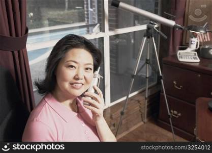 Portrait of a mature woman talking on a cordless telephone