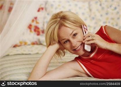 Portrait of a mature woman talking on a flip phone and smiling