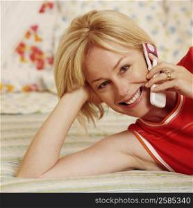 Portrait of a mature woman talking on a flip phone and smiling