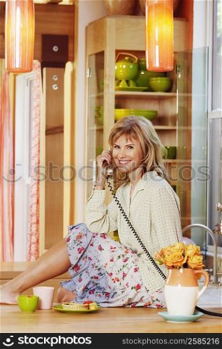 Portrait of a mature woman talking on the telephone and smiling