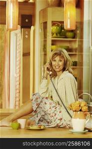 Portrait of a mature woman talking on the telephone and smiling