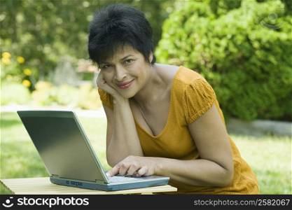 Portrait of a mature woman using a laptop and smiling