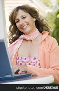 Portrait of a mature woman using a laptop and smiling