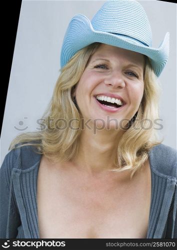 Portrait of a mature woman wearing a cowboy hat and smiling