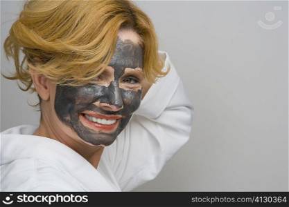 Portrait of a mature woman wearing facial masks and smiling