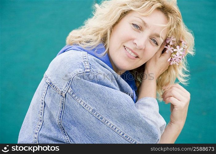 Portrait of a mature woman wearing flowers in her hair and smiling