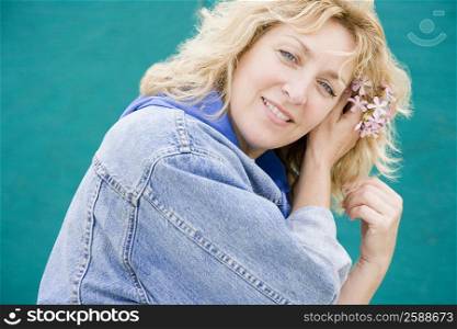 Portrait of a mature woman wearing flowers in her hair and smiling