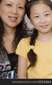 Portrait of a mature woman with her daughter smiling
