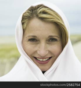 Portrait of a mature woman wrapped in a shawl and smiling