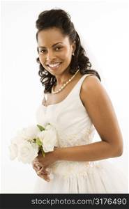 Portrait of a mid-adult African-American bride holding bouquet.