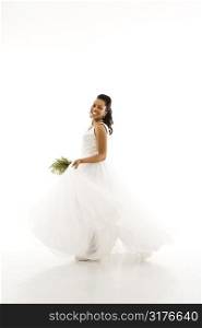Portrait of a mid-adult African-American bride holding bouquet.