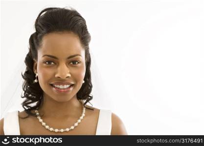 Portrait of a mid-adult African-American bride on white background.