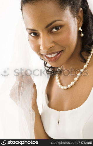 Portrait of a mid-adult African-American bride on white background.