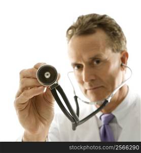 Portrait of a mid-adult Caucasian male doctor holding out stethoscope.