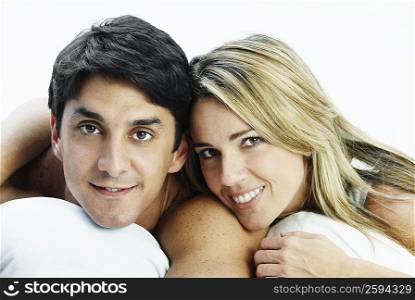 Portrait of a mid adult couple lying on the bed and smiling