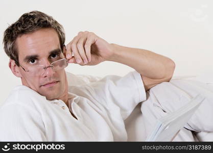 Portrait of a mid adult man adjusting his eyeglasses