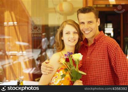 Portrait of a mid adult man and a teenage girl smiling