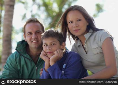 Portrait of a mid adult man and a young woman and their son
