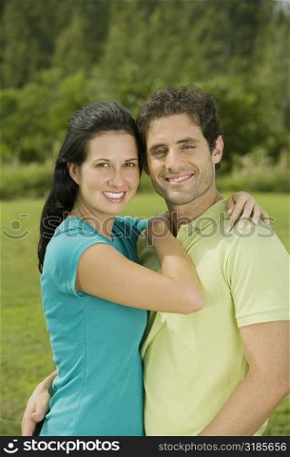 Portrait of a mid adult man and a young woman embracing each other