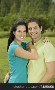 Portrait of a mid adult man and a young woman embracing each other