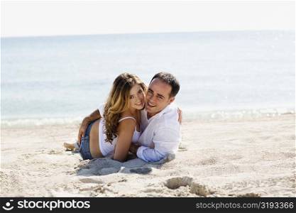 Portrait of a mid adult man and a young woman on the beach