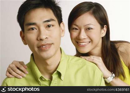 Portrait of a mid adult man and a young woman posing and smiling