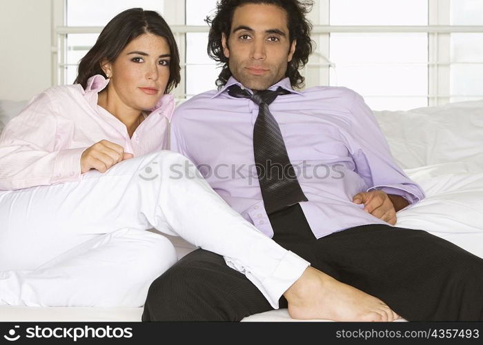 Portrait of a mid adult man and a young woman sitting on a couch