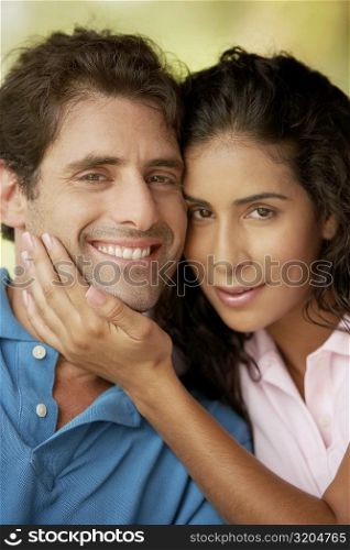 Portrait of a mid adult man and a young woman smiling