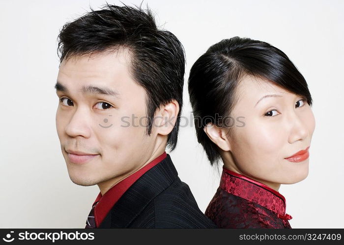 Portrait of a mid adult man and a young woman smiling