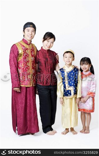 Portrait of a mid adult man and a young woman standing with their children