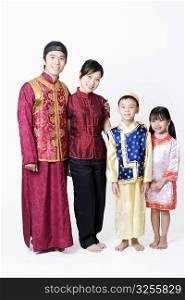 Portrait of a mid adult man and a young woman standing with their children