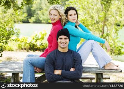 Portrait of a mid adult man and two young women smiling