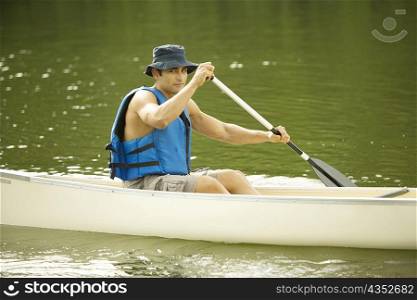 Portrait of a mid adult man boating in a river