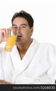 Portrait of a mid adult man drinking a glass of juice