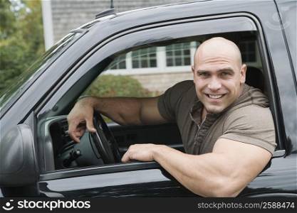 Portrait of a mid adult man driving a car