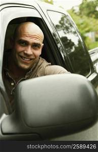 Portrait of a mid adult man driving a car