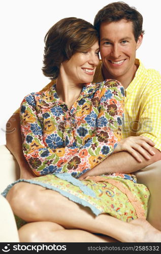 Portrait of a mid adult man embracing a mid adult woman and smiling