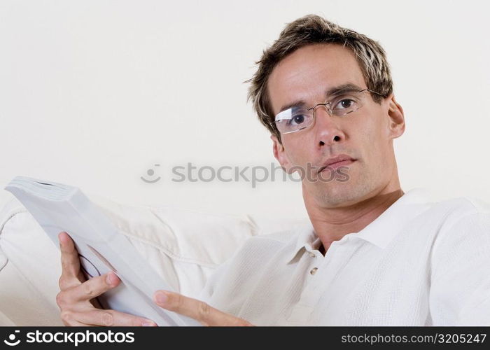 Portrait of a mid adult man holding a book