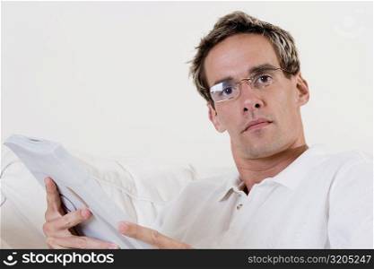 Portrait of a mid adult man holding a book