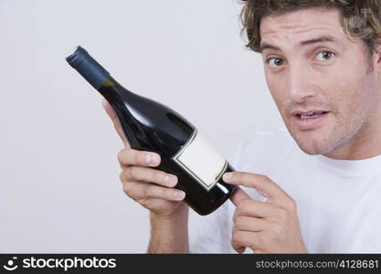 Portrait of a mid adult man holding a champagne bottle