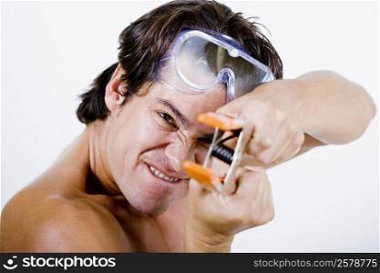 Portrait of a mid adult man holding a clamp